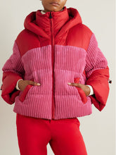 Person wearing a red and pink puffer jacket with matching pants on a plain background